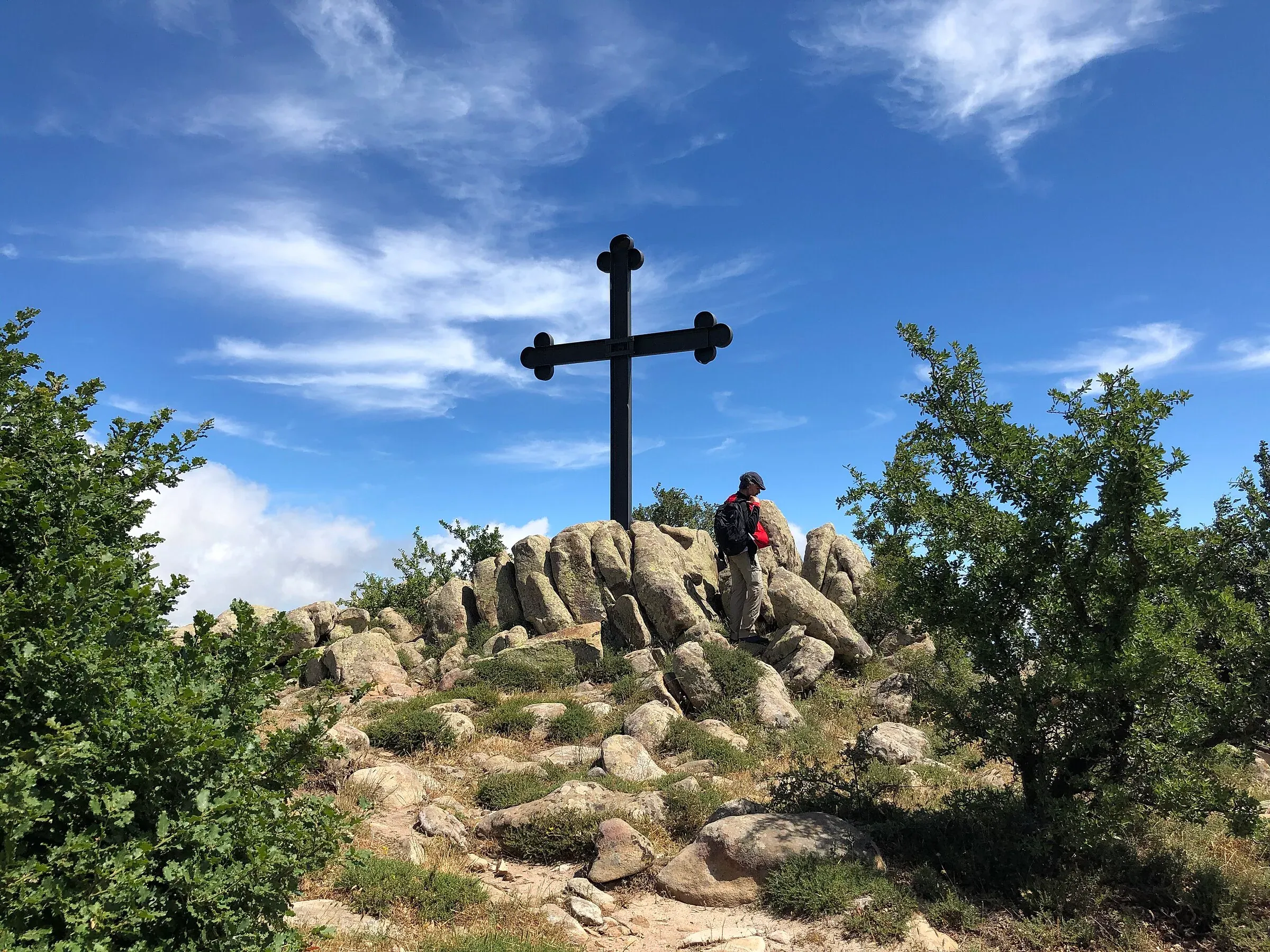 La croce sulla vetta di Cozzo Luminario, tra rocce e arbusti